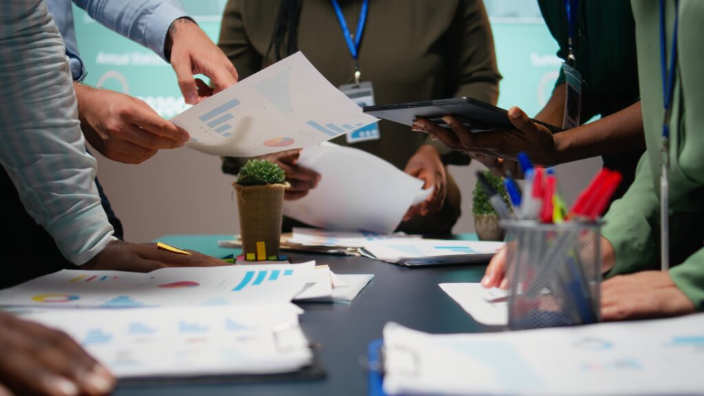 Office workers around a table going through documents about changes to policy and legal frameworks