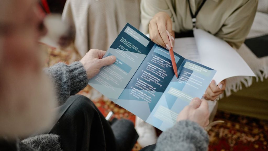 an adult social worker shows an elderly gent his options post adult social care reform
